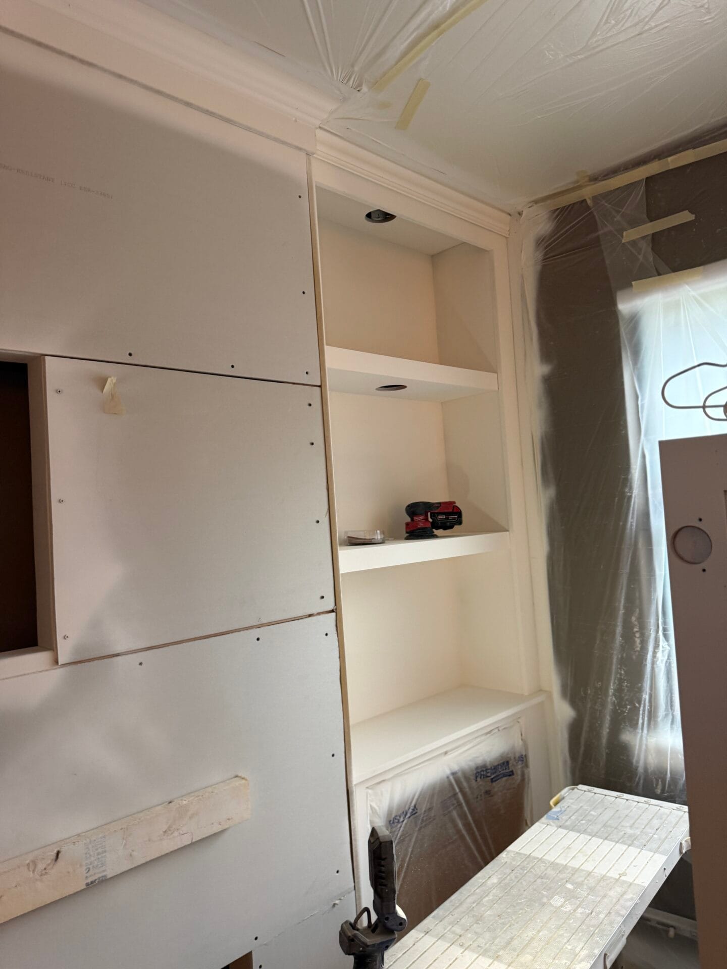 Drywall and custom shelf niches prepared for integrated LED lighting